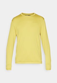 Top sportiv galben cu mânecă lungă, realizat din țesătură de plasă, având guler rotund, margini ribbed și un logo subtil pe piept.