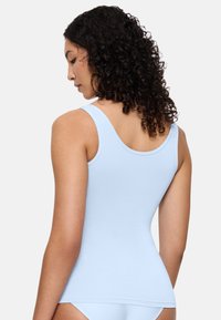 Light blue tank top with a fitted design, made of smooth fabric. Features wide shoulder straps and a rounded back neckline.
