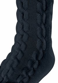 Czarna dziana skarpetka o teksturowanym, prążkowanym wzorze. Materiał wydaje się miękki i elastyczny, z zygzakowatym wzorem na powierzchni.