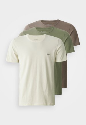 Three crew-neck t-shirts in cream, olive green, and brown. Made from soft cotton, featuring a small logo on the chest.