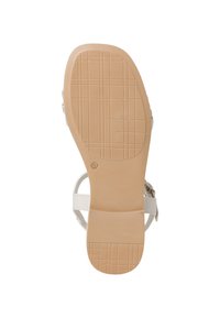 Semelle de sandale blanche avec un motif texturé, légèrement rembourrée, avec une finition lisse ; ornée d'une seule sangle et d'une boucle réglable.