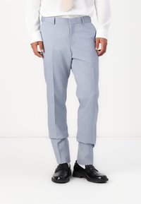 Pantaloni albastre deschiși, ajustați, cu o textură netedă, pliuri ascuțite și o croială dreaptă, asortați cu pantofi din piele negri.
