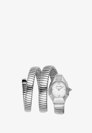 Montre-bracelet à spirale argentée avec un cadran texturé, des chiffres romains et des cristaux décoratifs sur un boîtier hexagonal et aux extrémités du bracelet.