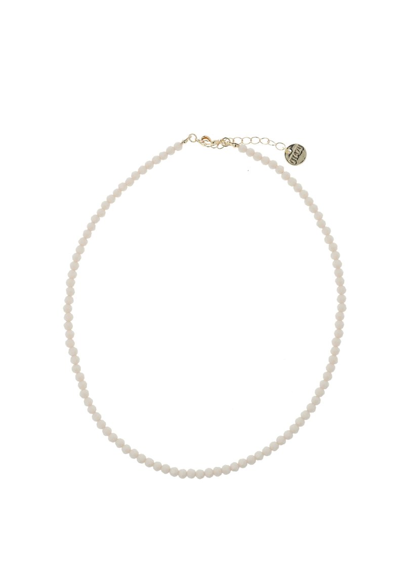 Witte kralenketting met kleine ronde kralen, gouden sluiting en verlengkettinkje met een ronde tag. Gladde textuur overal.