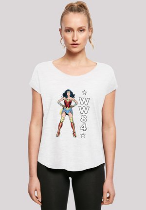 White short-sleeve T-shirt featuring a comic-style Wonder Woman graphic, with "WW84" and stars in bold black font beside the character.