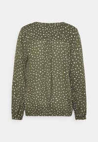 Blouse à manches longues vert olive à pois blancs, avec un col rond et un pli au dos. Texture lisse avec des poignets boutonnés.