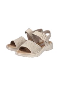 Light beige open-toe sandals with mesh upper, cushioned footbed, adjustable strap with buckle, and textured rubber sole.