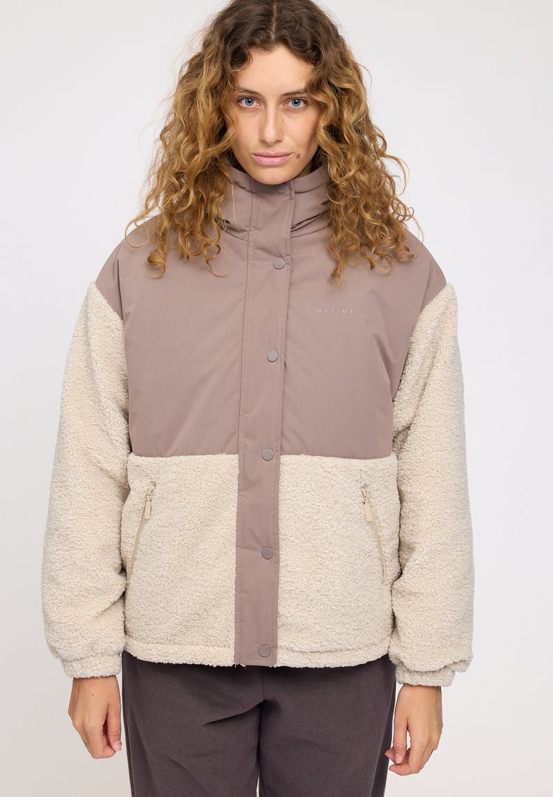 Padded jacket with a brown and cream color scheme, featuring a high collar, zippered pockets, and a soft, textured exterior.