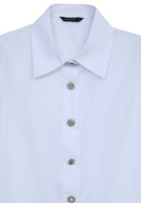 White collared blouse with five decorative silver buttons, including one with a pearl detail, and a black size tag inside collar.