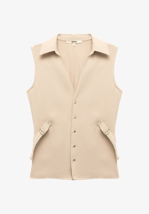Beige sleeveless vest with a pointed collar, button front closure, and side straps with buckles. Smooth fabric with a minimalistic design.