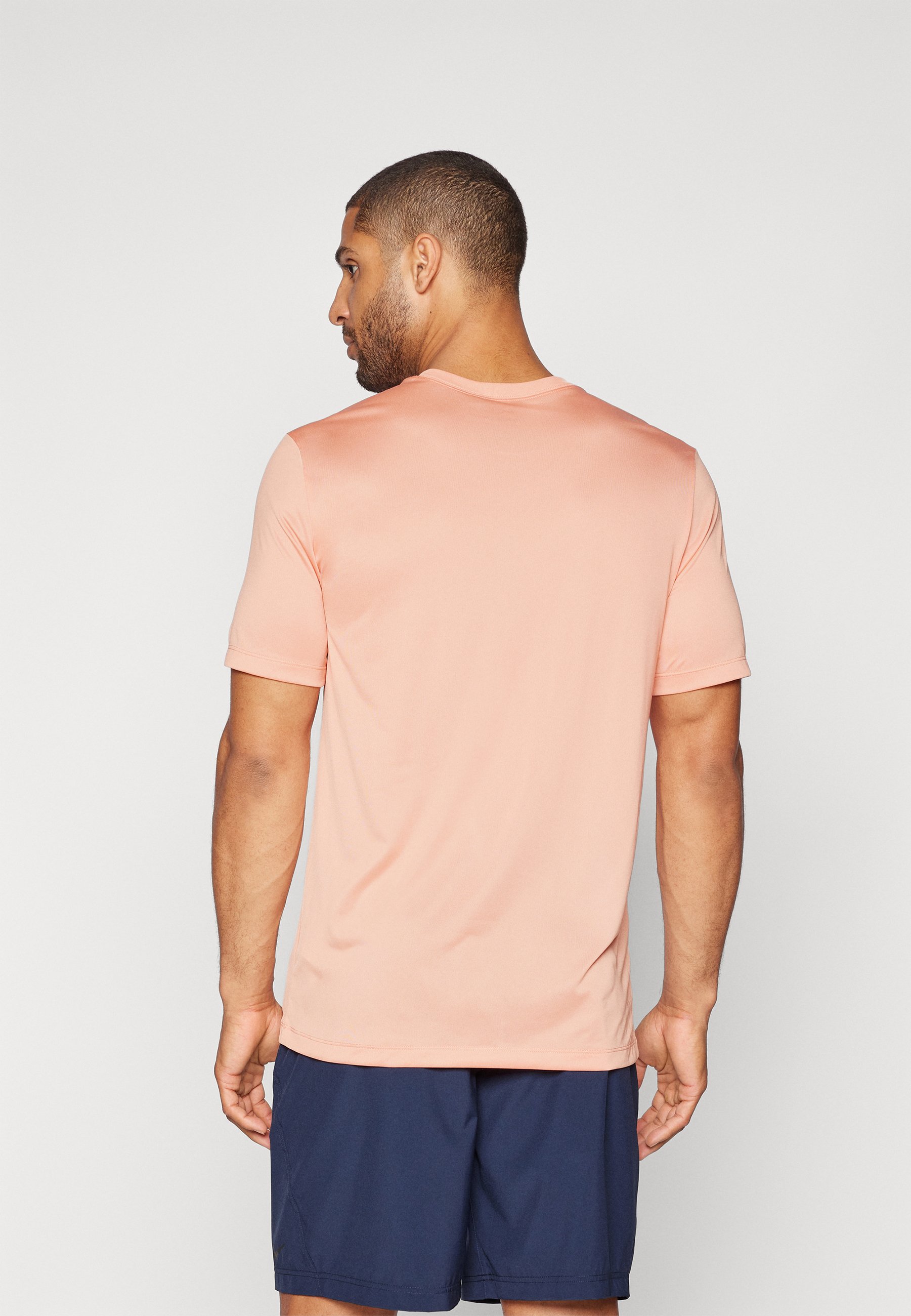 peach color nike shirt