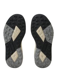 Suole di scarpe in gomma nere e grigie con battistrada triangolare e accenti beige. Superficie testurizzata per la presa, con sezioni rialzate per la trazione.