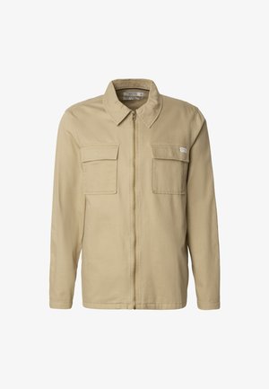 Beige arbeidsjakke med glidelås foran, to brystlommer, spiss krage og lange ermer. Laget av slitesterkt, teksturert stoff.