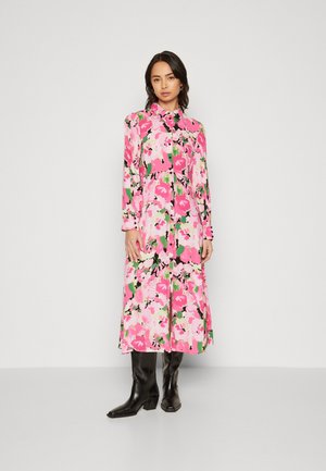 Floral midi dress featuring a vibrant pink, black, and green pattern, made of light fabric with long sleeves and a button-down front.