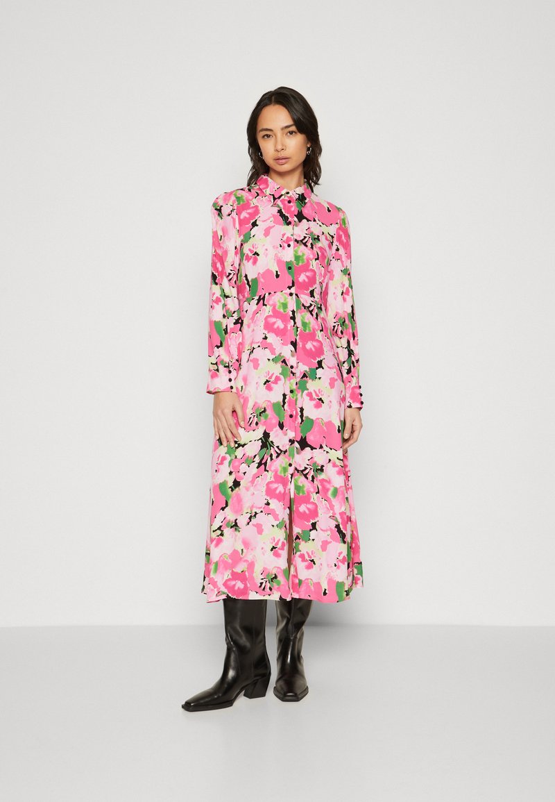 Floral midi dress featuring a vibrant pink, black, and green pattern, made of light fabric with long sleeves and a button-down front.
