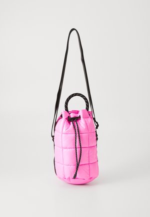 Pink quilted drawstring bucket bag with black rope handle and adjustable long black shoulder strap against white background.