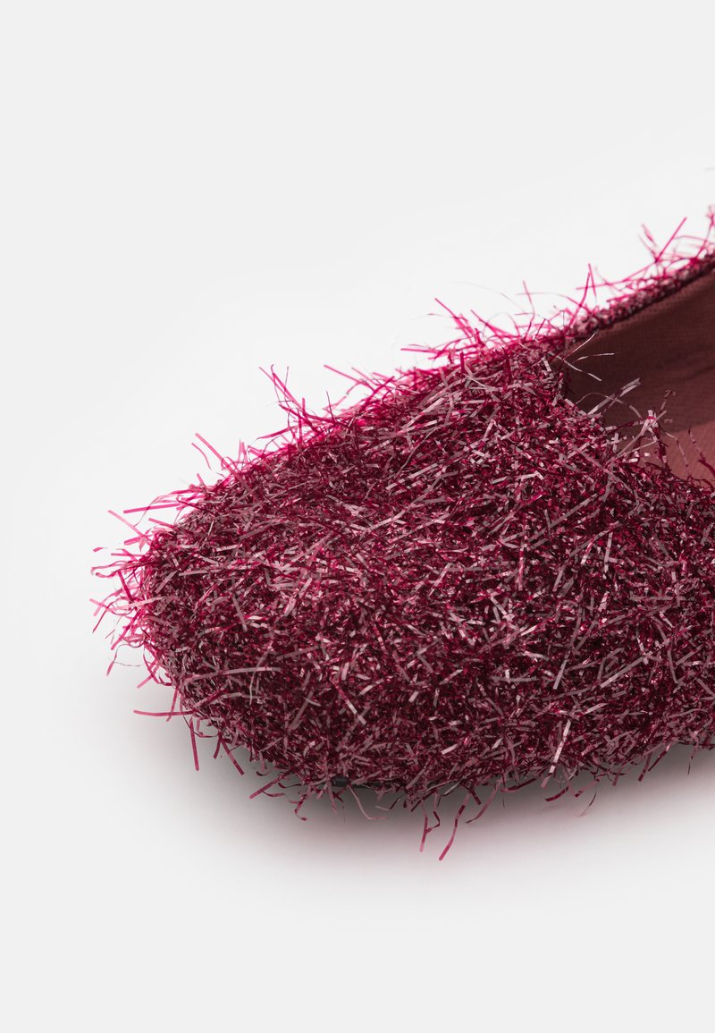Shiny burgundy shoe with a textured upper made of vibrant, synthetic fibers, featuring an almond toe and smooth inner lining.