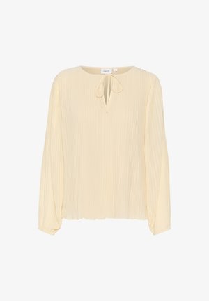 Faltenbluse mit langen Ärmeln in hellem Creme mit einer Schlüsselloch-Bindung. Weicher, leichter Stoff mit einer dezenten strukturierten Oberfläche.