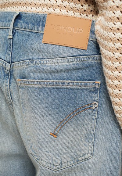 Light blue denim jeans with a leather label branded "DON DUP MADE IN ITALY." Features stitching accents and a distinct pocket design.