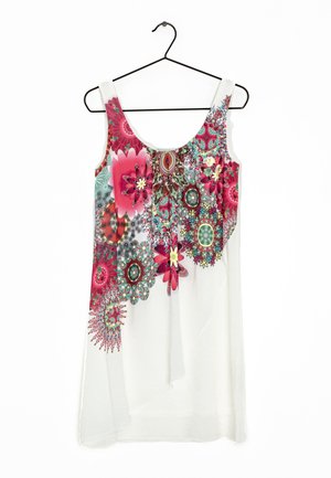 White sleeveless dress with colorful red, pink, green, and yellow floral and geometric patterns, hanging on a black hanger.