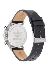 Stainless steel watch with a black leather strap. Features a minimalistic design with silver-tone hardware and a branded back.