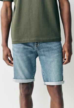 Leren denim shorts in lichtblauw, met een klassieke vijf-pocket stijl en opgerolde zomen. Het materiaal lijkt zacht en heeft een licht vervaagde afwerking.