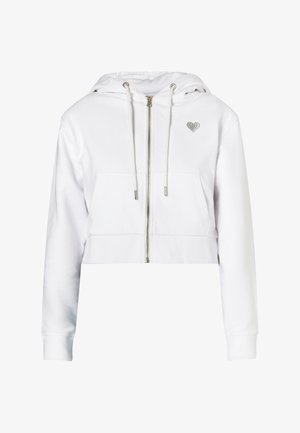 Supjaustyta balta pūkuota hoodie, turinti užtrauktuką priekyje, dvi priekinės kišenes ir mažą sidabrinę širdelę ant krūtinės.