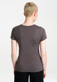 Short-sleeve t-shirt in dark gray, fitted design, smooth cotton material, round neckline, and minimal stitching details on the back.