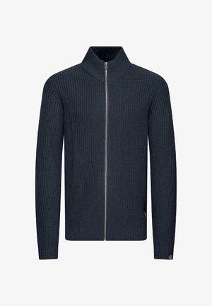 Navy zip-up knit sweater with a high collar, ribbed texture, and long sleeves. Features a silver zip and logo detail near the hem.