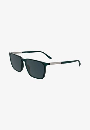 Grüne rechteckige Sonnenbrille mit dunklen Gläsern, Metallakzenten an den Bügeln und glänzender Oberfläche. Beinhaltet ein Calvin Klein-Logo am Scharnier.