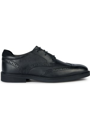 Scarpa da uomo in pelle nera con dettagli brogue, chiusura con lacci, punta arrotondata e suola in gomma testurizzata. Design classico con accenti sobri.