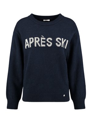 Suéter azul marino con "APRÈS SKI" tejido en blanco. Presenta un cuello redondo y puños acanalados, textura suave y un diseño ajustado.