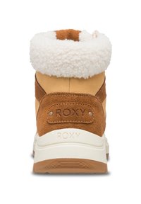 Bruine suède laars met een witte fleece kraag, vlakke witte rubberen zool en Roxy branding op de hiel. Het ontwerp heeft een stevige vorm en een textuurcontrast.