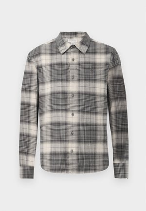 Langermet rutet skjorte i svart og krem. Har knapplukking foran, klassisk krage og variert rutemønster. Myk stofftekstur.