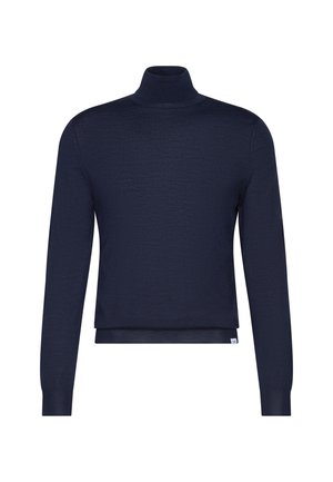 Pull col roulé bleu marine à manches longues avec des poignets ajustés et une petite étiquette blanche près de l'ourlet.