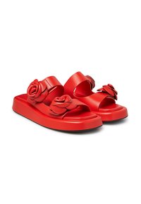 Red sandal with two wide bands, featuring raised rose accents. The material appears smooth and synthetic, with a chunky sole for support.