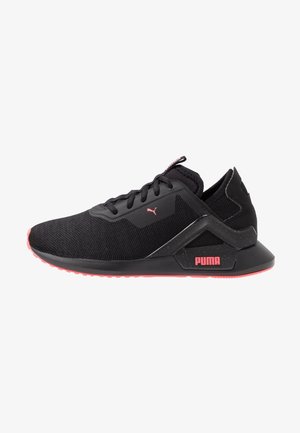 Černá běžecká bota Puma s růžovým logem, růžovými okraji podrážky, síťovaným svrškem a hranatou oporou paty, pohled ze strany na bílém pozadí.