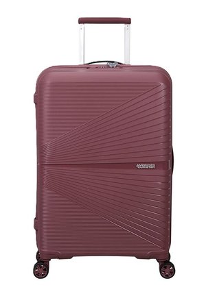 Valigia rigida bordeaux con texture a coste diagonali, quattro ruote girevoli e manico telescopico estensibile.