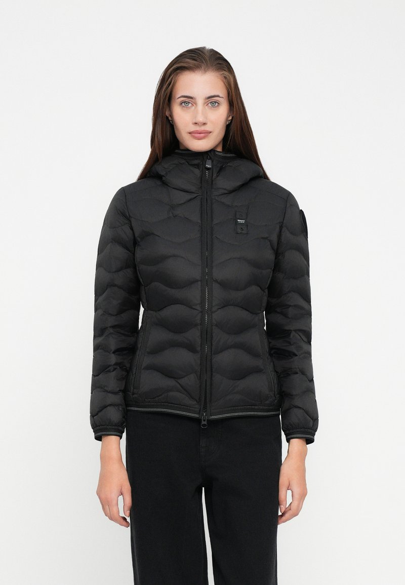 Black puffer jacket with a hood, featuring a quilted design, front zipper, and slim fit. The material appears smooth and lightweight.