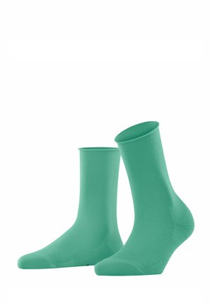 Ein Paar mintgrüne Socken aus einem weichen, dehnbaren Material. Verfügt über ein Crew-Längen-Design mit geripptem oberen Teil und verstärktem Zehenbereich.