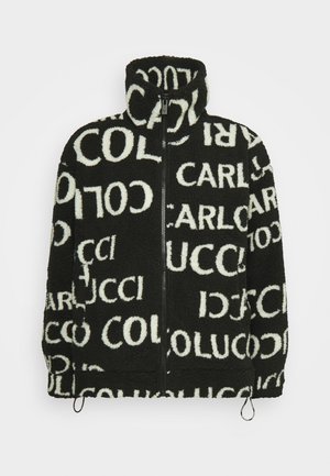 Black fleece jacket with high collar, bold white lettering throughout, zip front closure, and adjustable hem drawstrings.