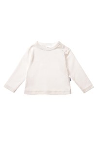 Langärmliges Kinderoberteil in Off-White, aus weicher Baumwolle gefertigt. Mit Rundhalsausschnitt und Knopfdetails an der Schulter.