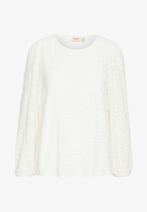 Baltā blūze ar garām piedurknēm un teksturētu zebras rakstu. Iezīmē apaļu izgriezumu un brīvu piegriezumu, izstrādāta no mīksta auduma.