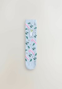 Light blue socks featuring a white snowman, pink candy canes, green holly leaves, and silver accents in a playful pattern.