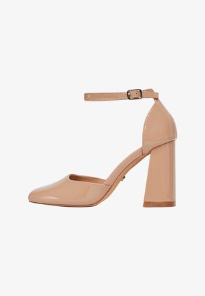 Nagu lakota eleganti ar potīti, apaļu purngalu, masīvu papēdi un gludu, spīdīgu virsmu. Potītē iestrādāts metāla sprādzes akcenta siksniņa.