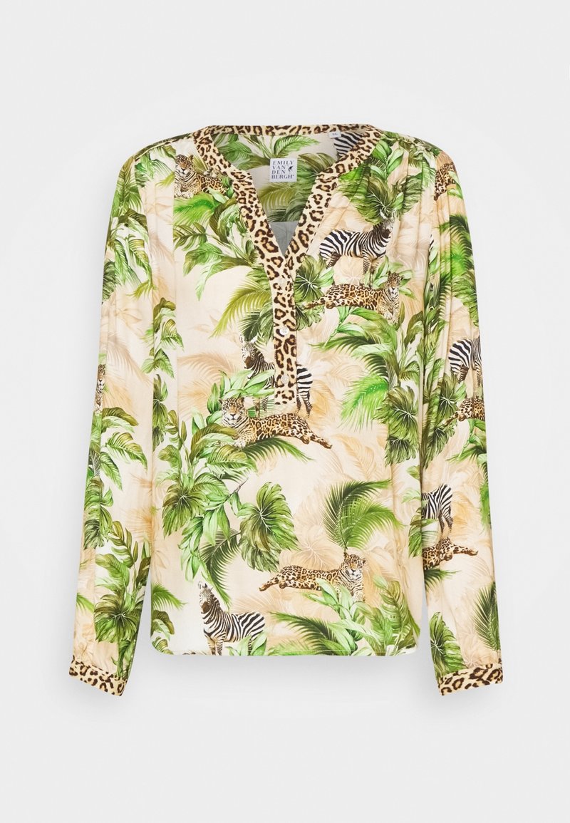Blouse crème à manches longues avec des feuilles tropicales vertes, des imprimés léopard et zèbre, et une bordure imprimé léopard sur le col et les poignets.