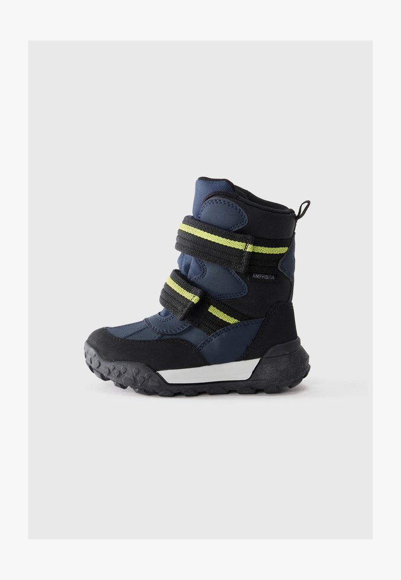 Water-resistant navy and black boots with a textured black rubber sole, dual adjustable Velcro straps, and reflective yellow accents.