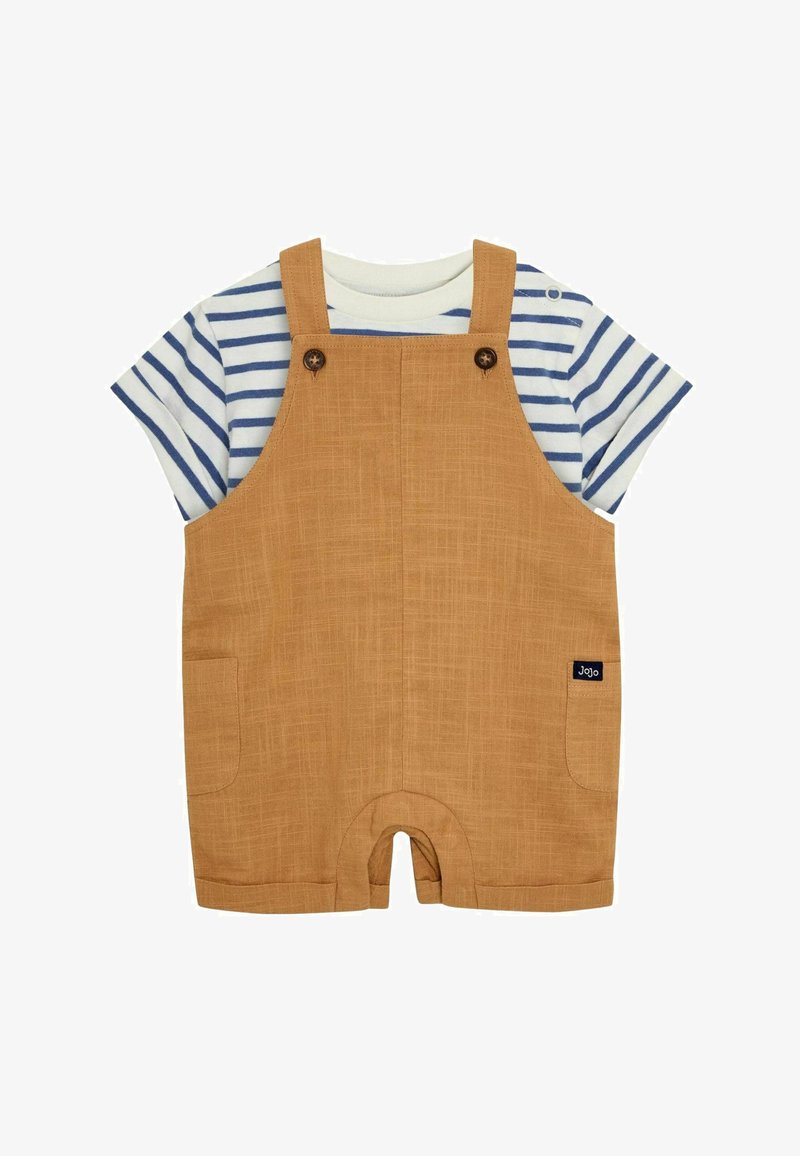 Tan overalls with textured fabric, featuring two side buttons, one pocket, and a navy logo tag, layered over a blue and white striped T-shirt.