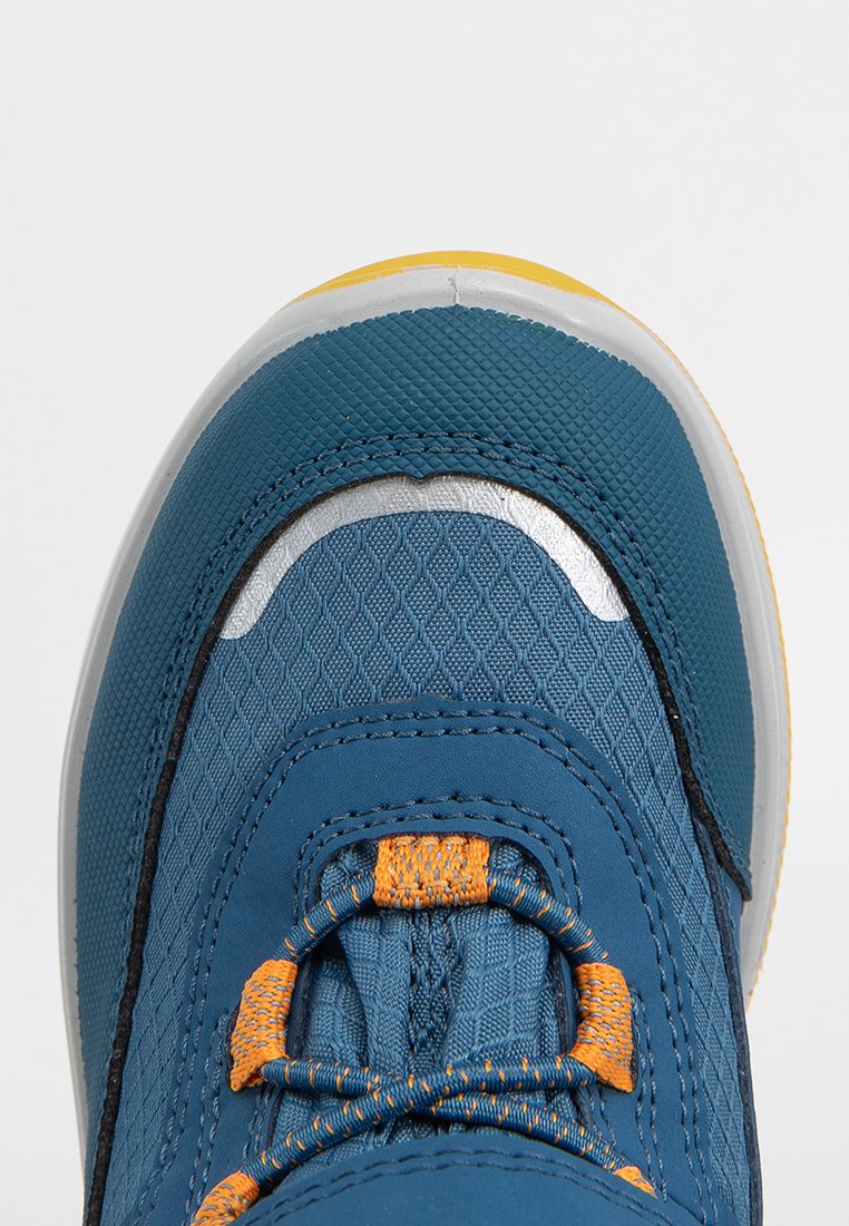 Blauer und gelber Sneaker aus strukturiertem Material, mit orangen und blauen Schnürsenkeln sowie reflektierendem silbernem Detail im Zehenbereich.