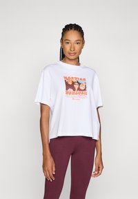 White cotton t-shirt with short sleeves and a loose fit. Features a colorful graphic print that says “Besties Forever” on the front.